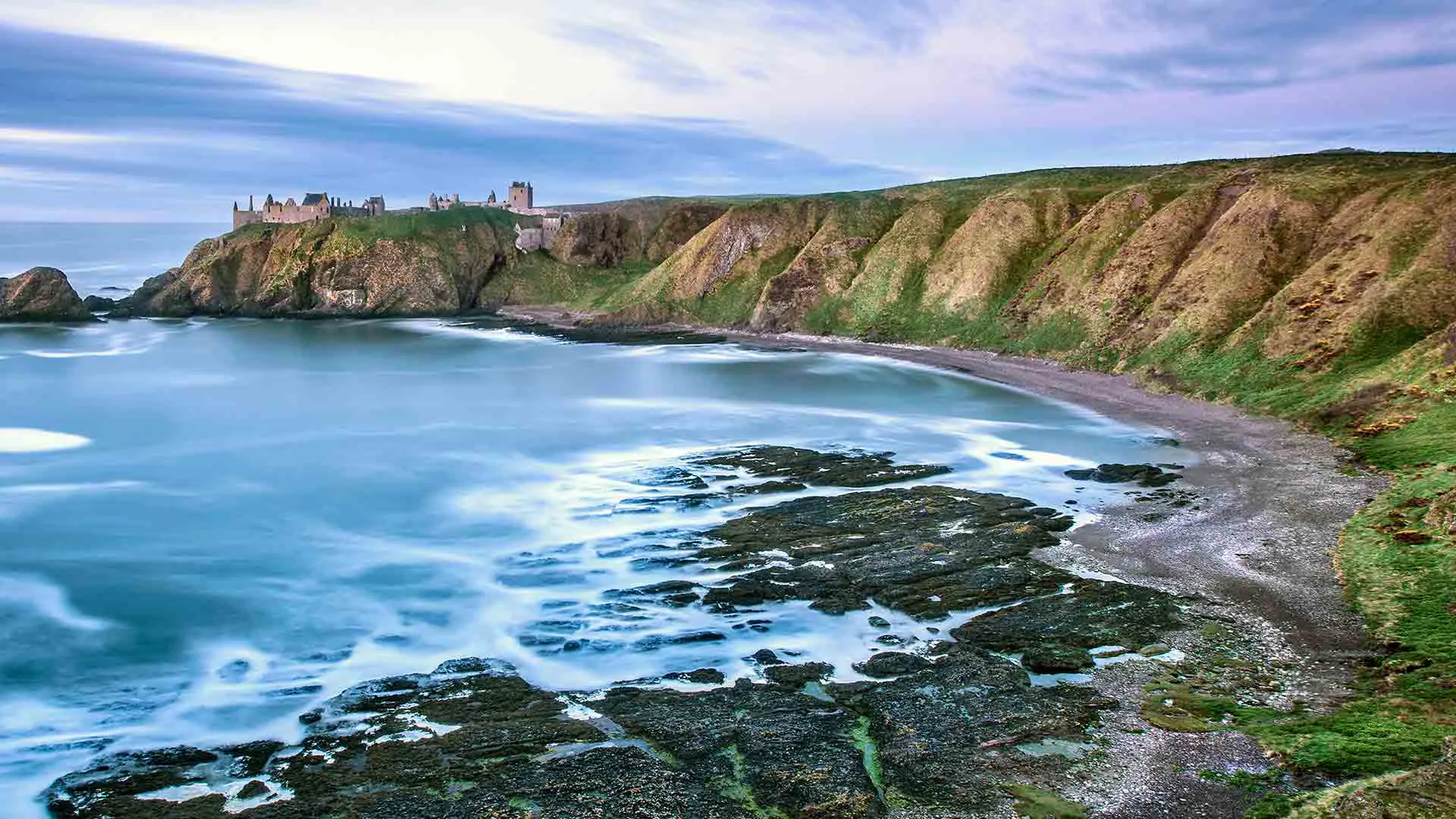 Coastal landscape with castle and moving water