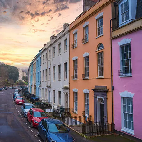 Colorful buildings in a city street at sunrise