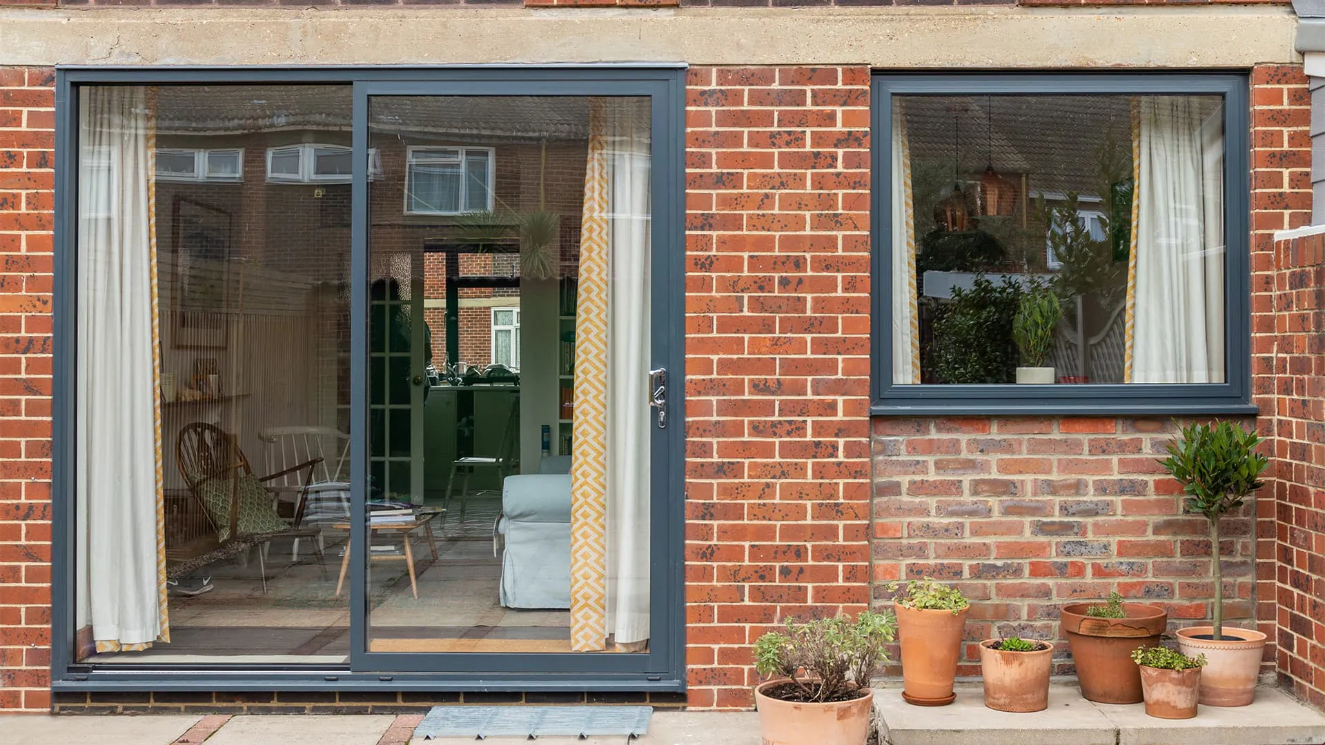 Grey Everest conservatory with sliding doors and  windows