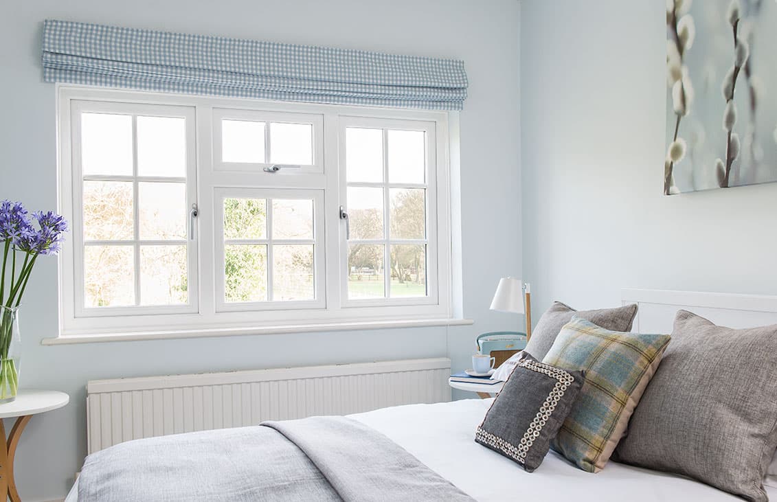 Light blue gingham window covering over white Everest conservatory windows