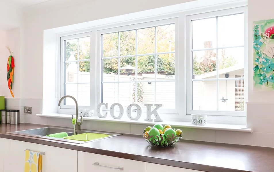 White kitchen window with wood counter and cook letters