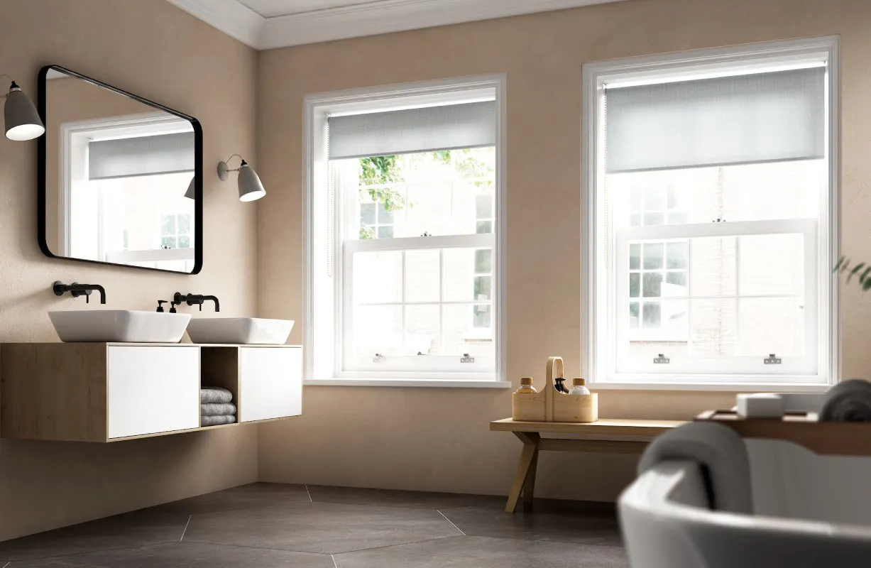 Beige bathroom with white double sinks and large windows