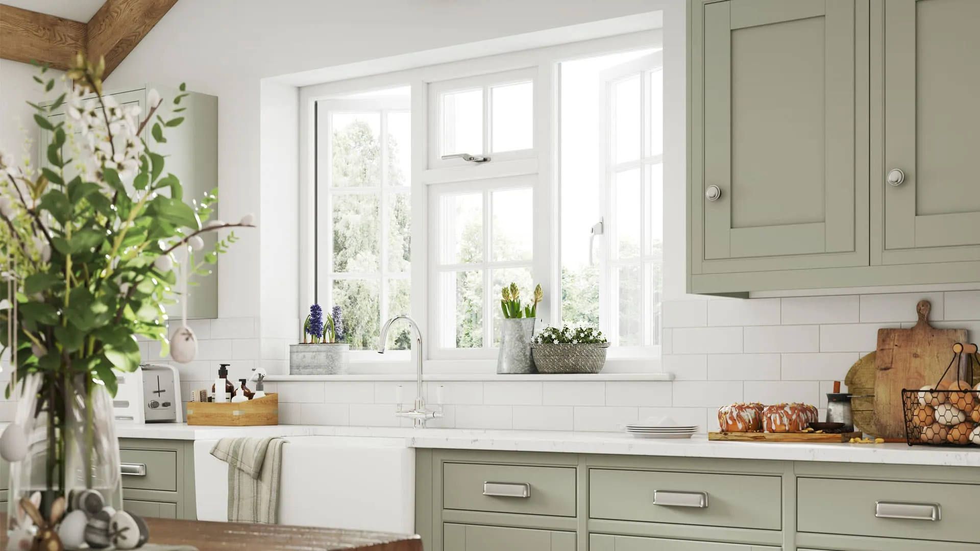 Sage green kitchen with white window and spring flowers