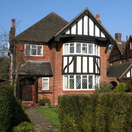 Brick house with black and white trim and bay window