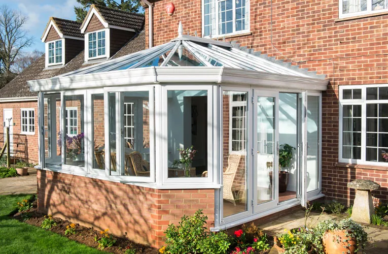 White Everest conservatory with brick house