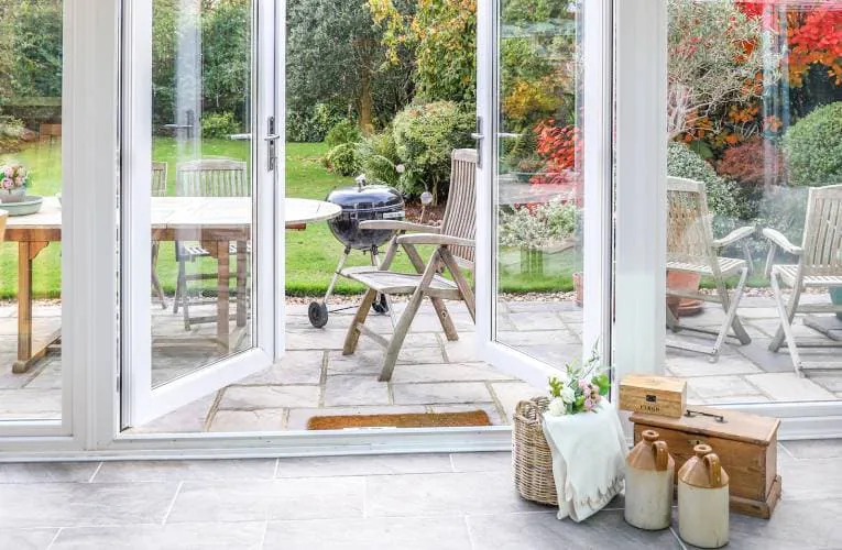 Everest conservatory patio with white doors and garden view