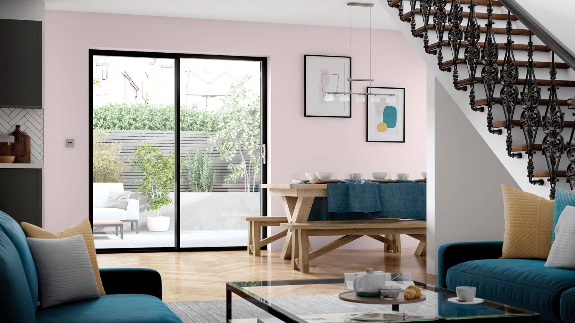 Pink walls open plan dining area with garden view