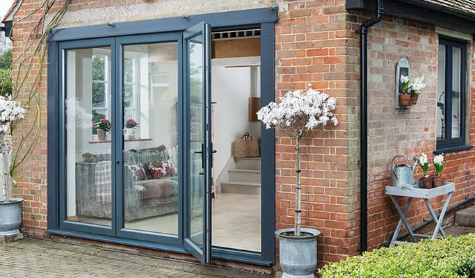 Everest conservatory grey bi-fold doors open
