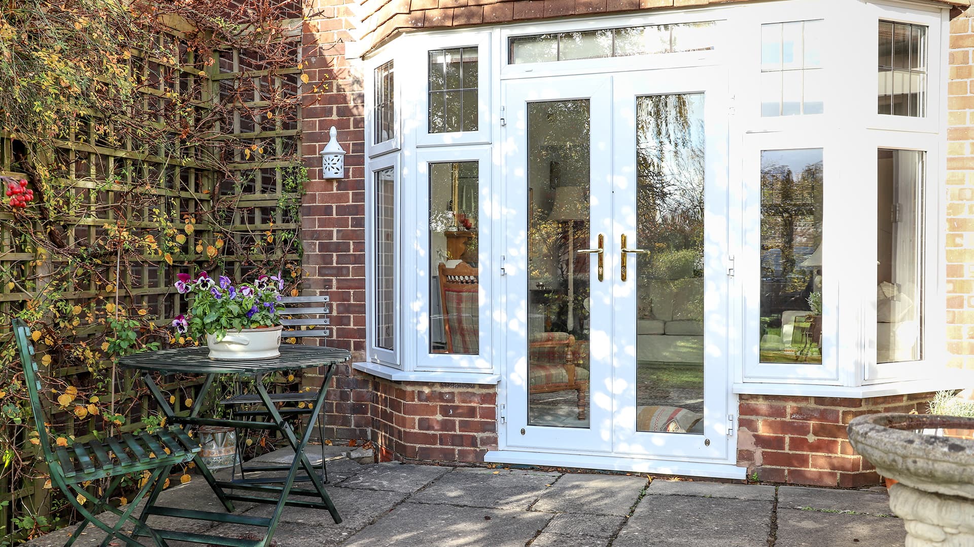 White Everest conservatory with garden patio furniture