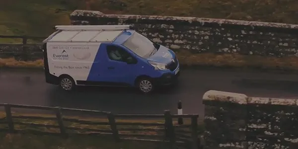 Everest van driving on a country road