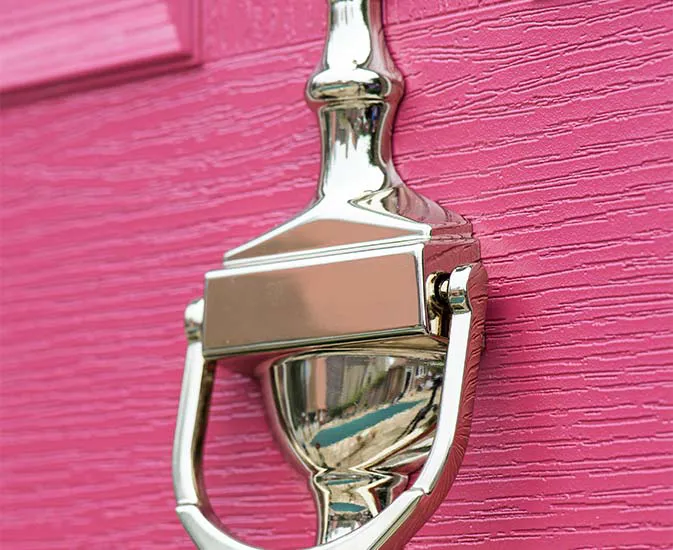 Pink door with a polished chrome door knocker