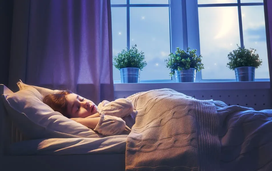 Child sleeping peacefully in bed at night