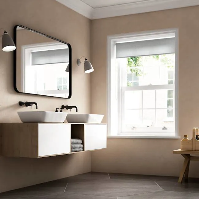 Modern bathroom with light beige walls light wood vanity and double sinks