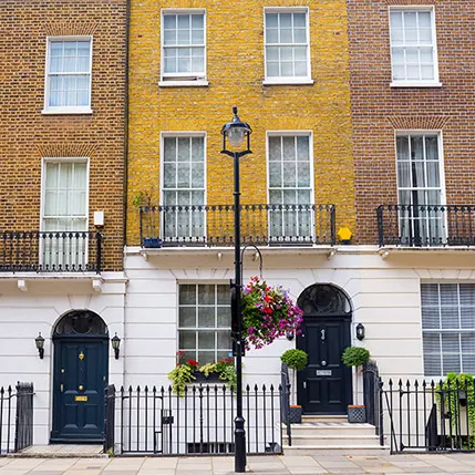 Two-toned brick house facade with white trim and black doors