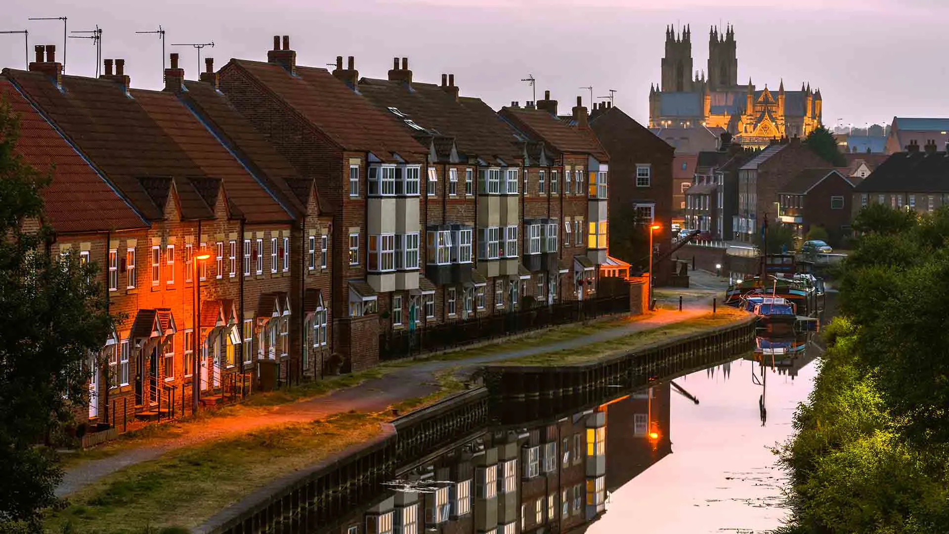 Brick townhouses riverside canal dawn light
