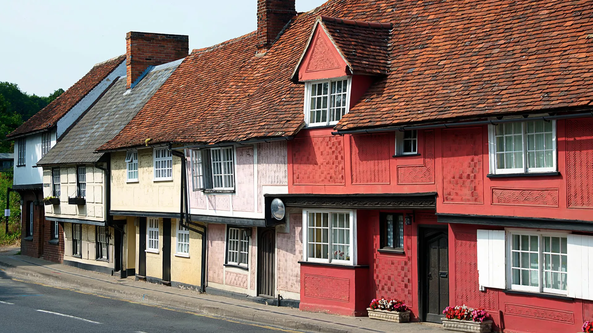 Row of colorful buildings with terracotta roofs