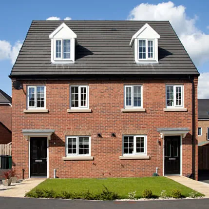 Two storey brick house with white windows and black door