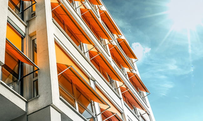 Everest conservatory orange awnings on building facade