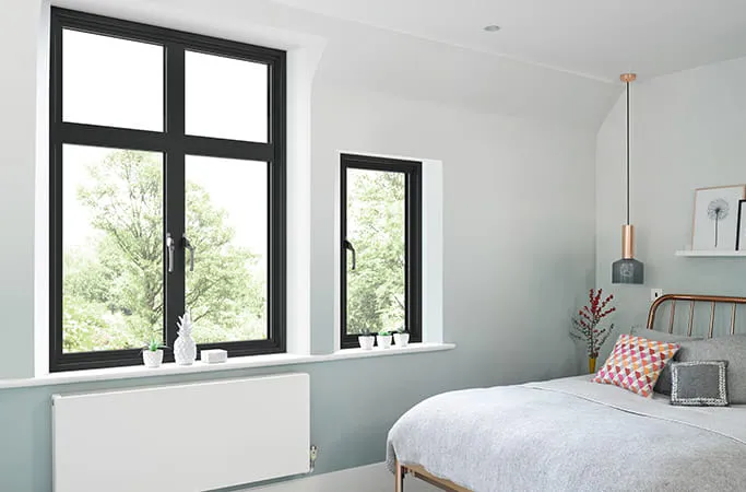 Black framed windows in a light blue room
