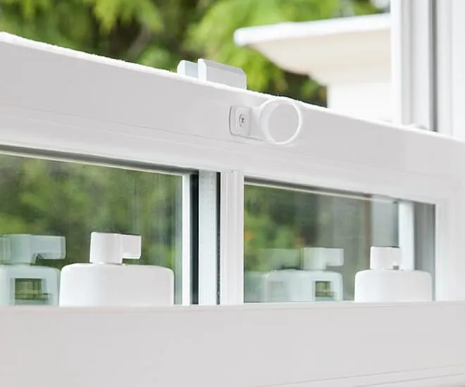 White window security devices on a white Everest conservatory window
