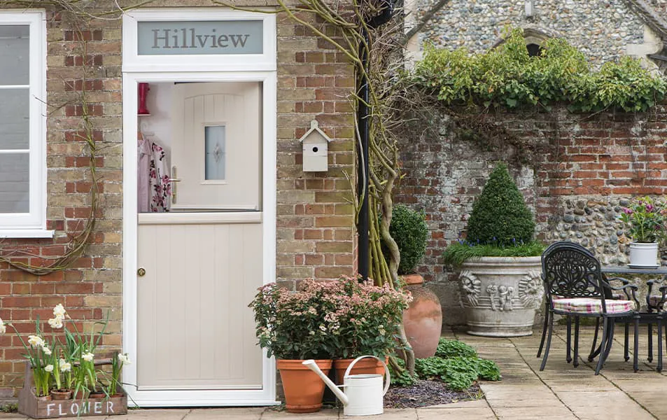 Cream coloured Everest door with decorative window and plants