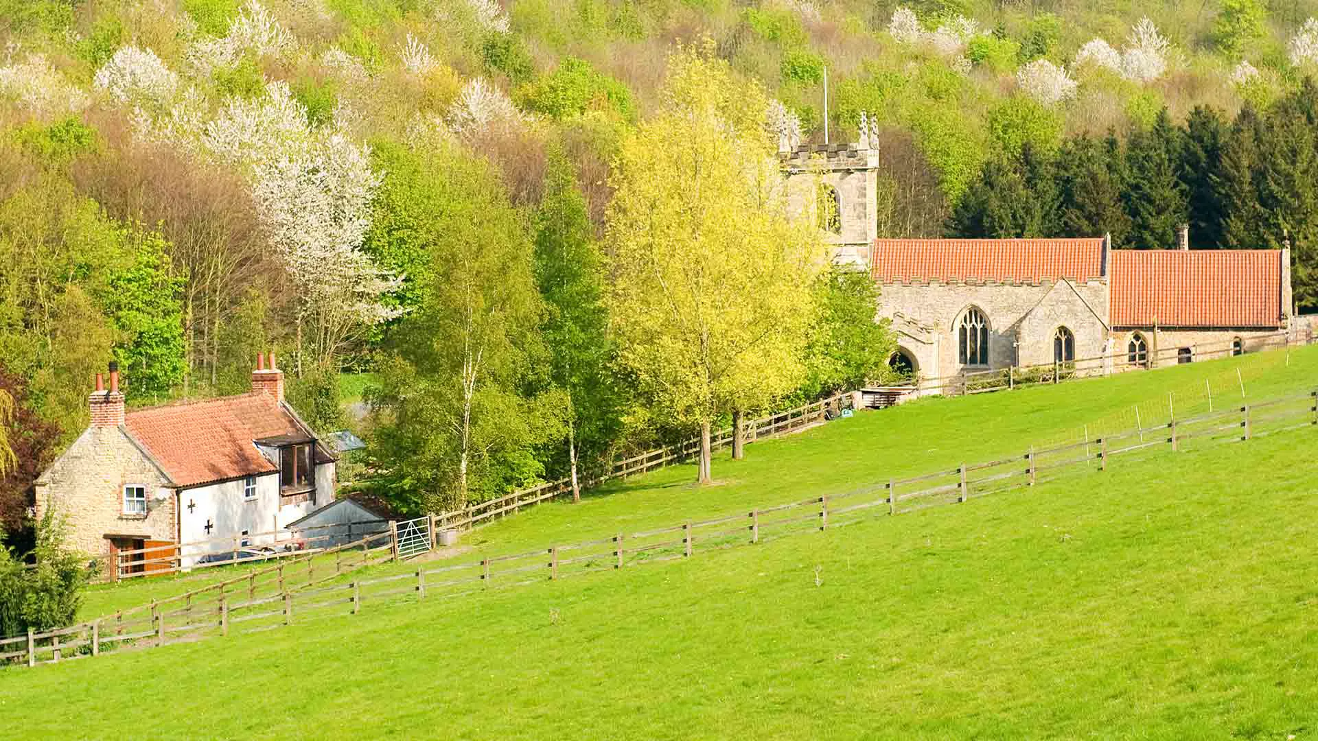 Rural scene with stone house church and green grass