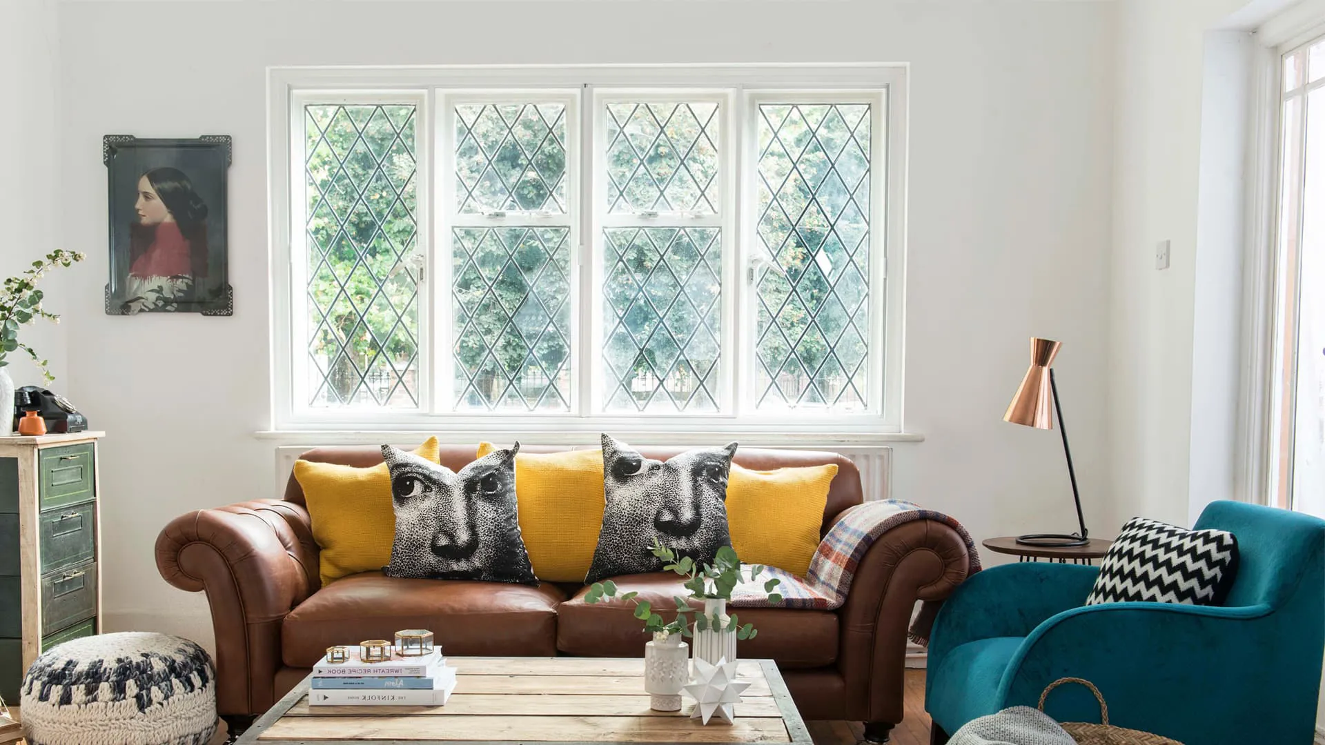 Brown leather sofa with yellow and black patterned cushions