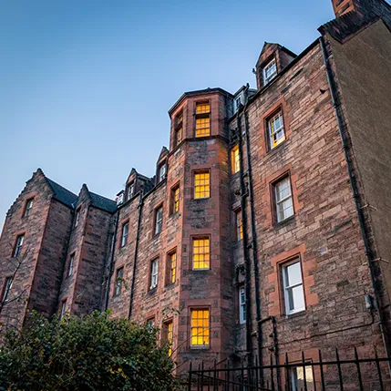 Edinburgh building with lit windows at dusk
