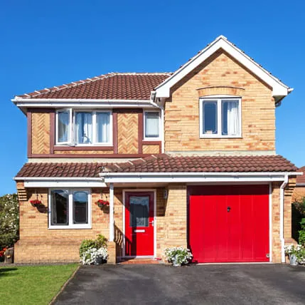 Brick house with red door and garage