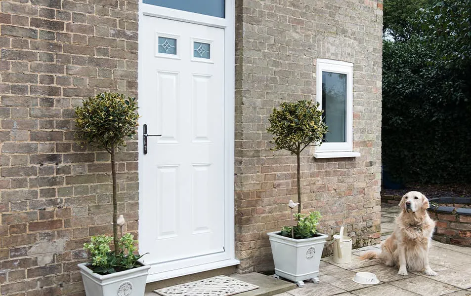 White door with brick exterior and plants