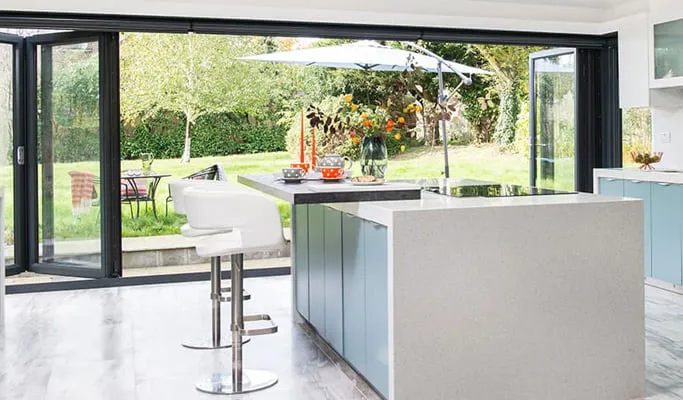 Everest conservatory with light grey kitchen island and pale blue cabinets