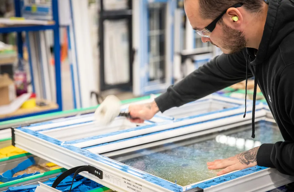 Person cleaning Everest conservatory window frame