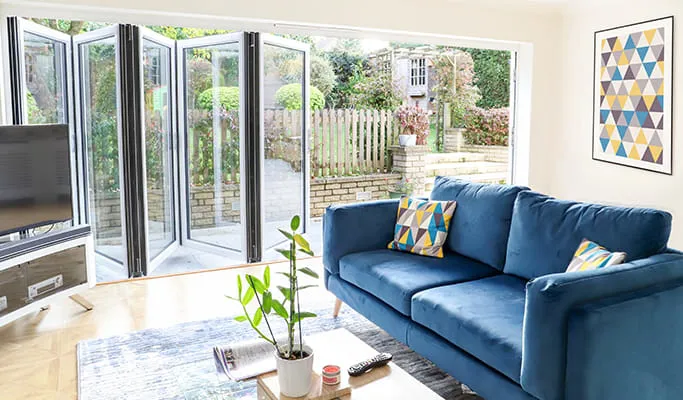 Everest conservatory with blue sofa and patterned cushions