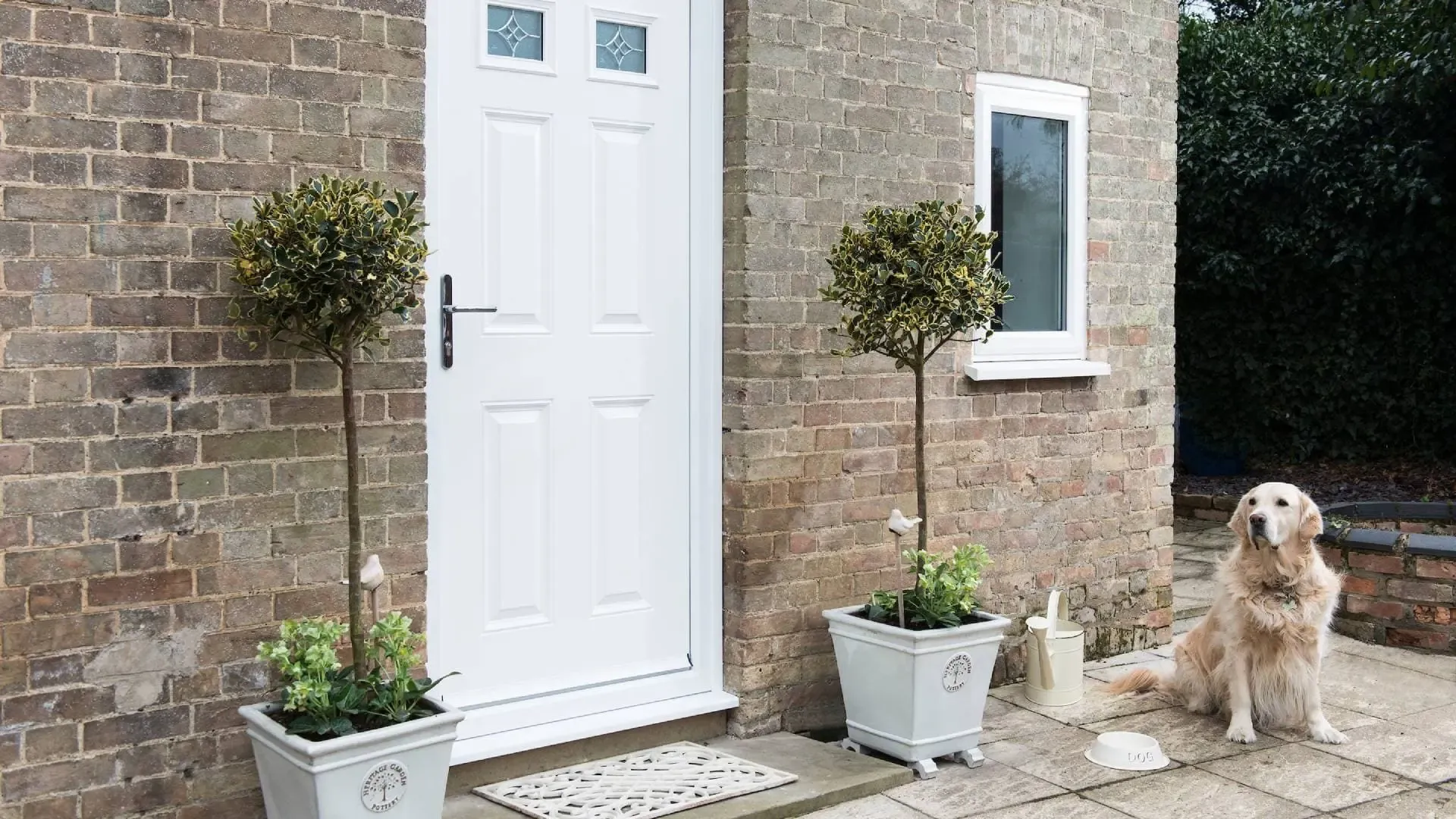 White door with brick exterior and potted plants