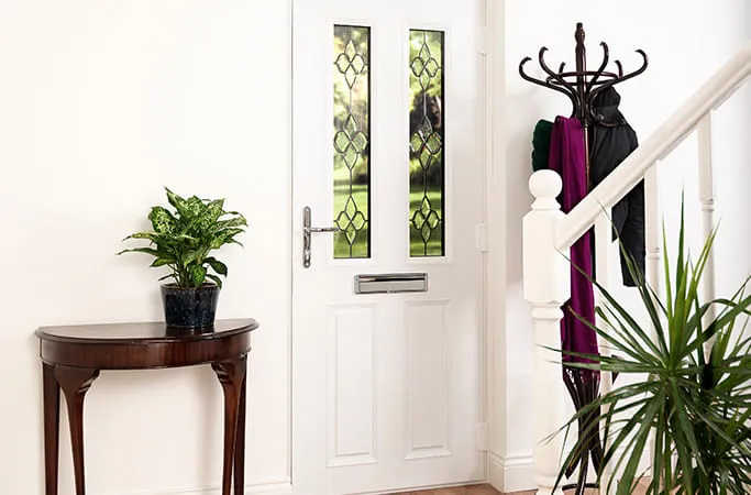 White door with decorative glass and plants
