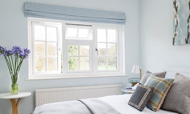 Light blue checkered window blind pale blue walls white window