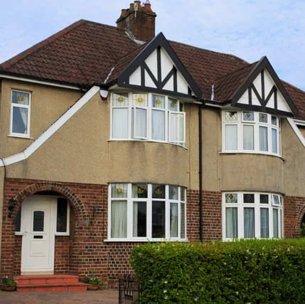 Two-story house with bay windows and a white door