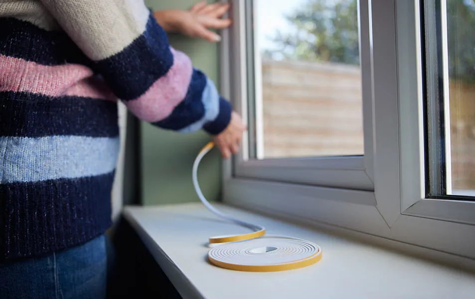 Person installing window sealant on Everest conservatory window