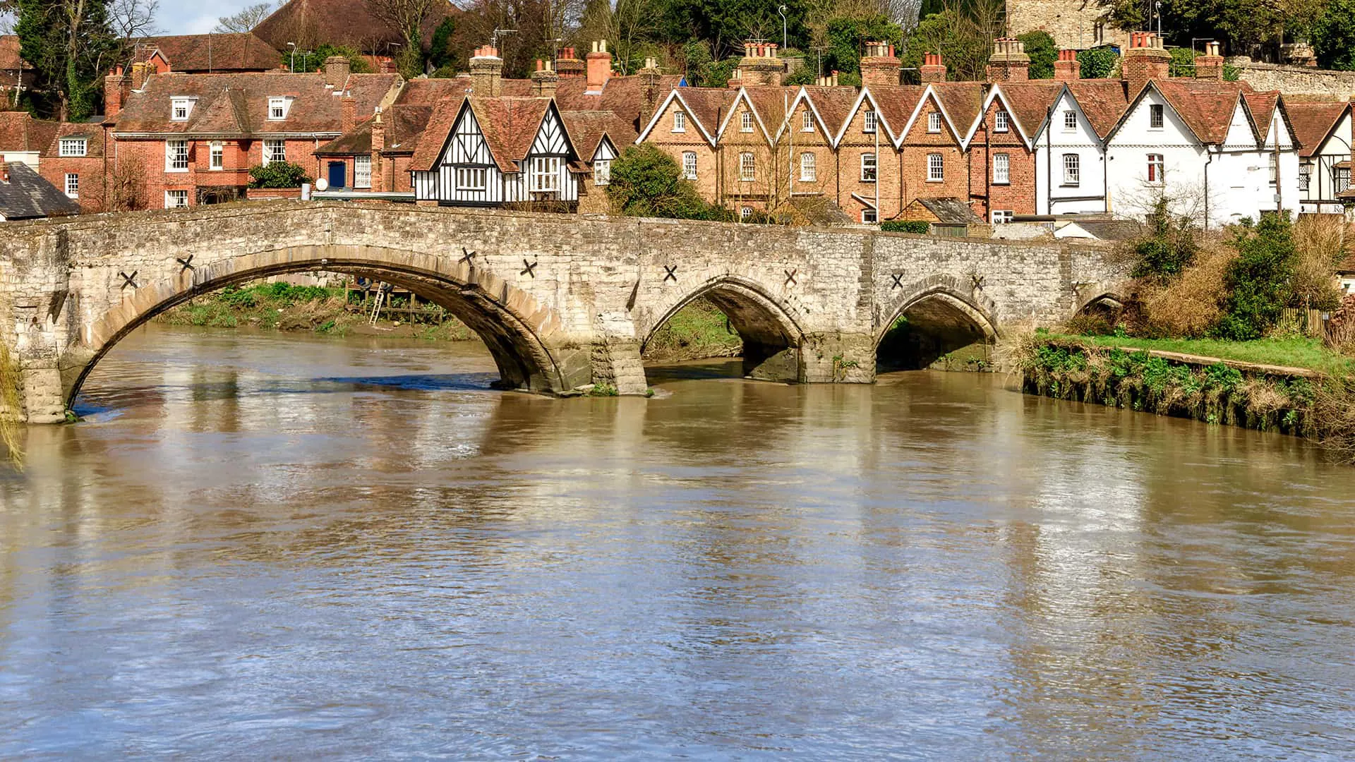 Stone bridge over a river with old houses