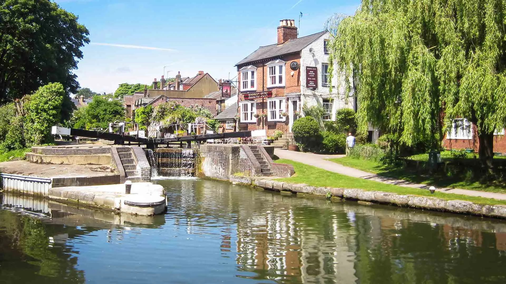 Canal towpath with pub and trees