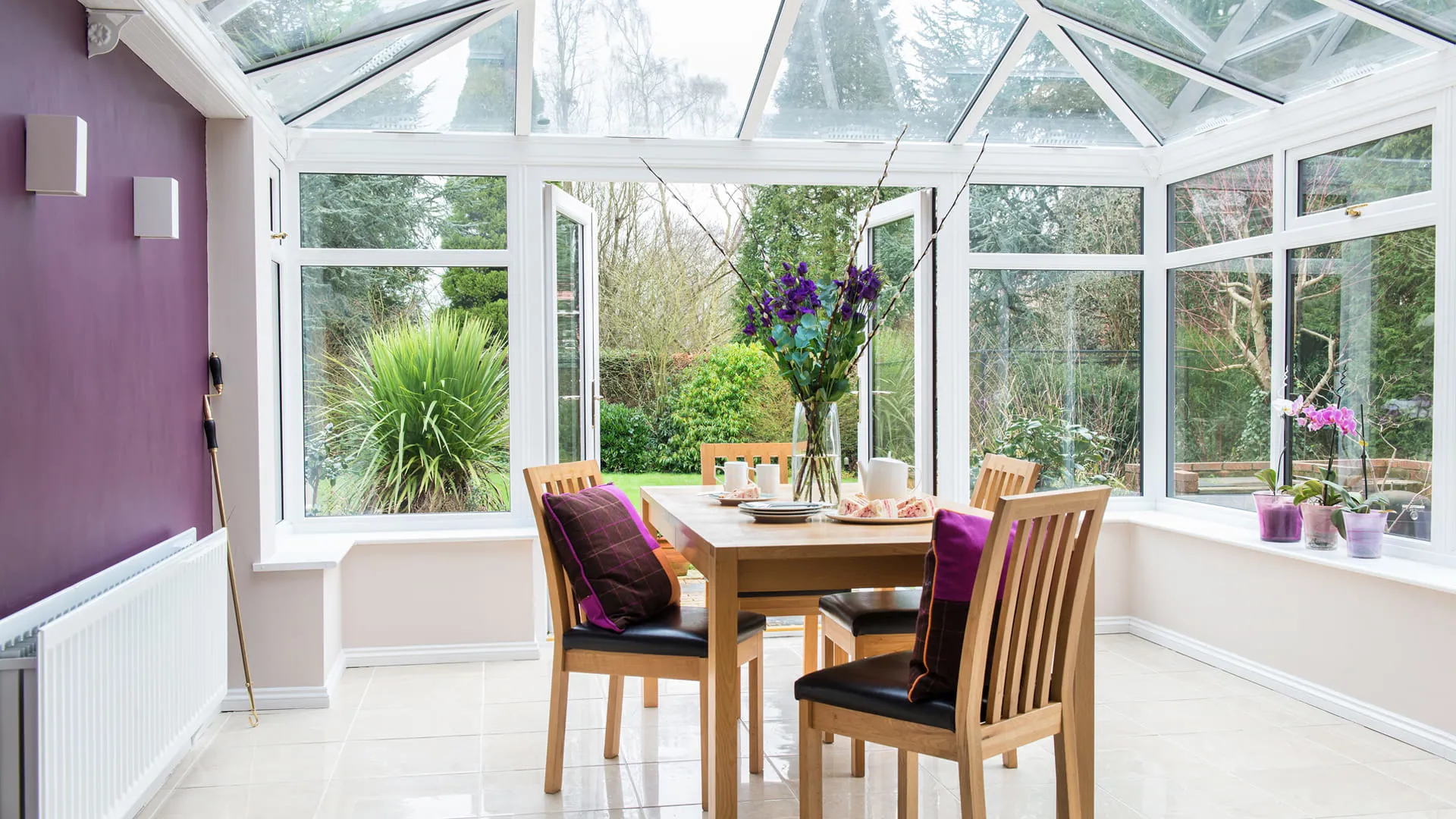 Everest conservatory dining area with purple accents
