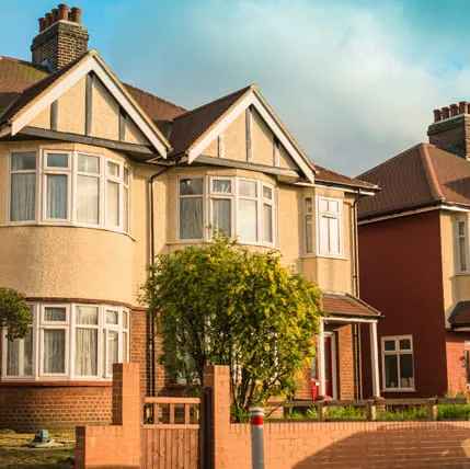 Beige houses with white windows and brown roofs