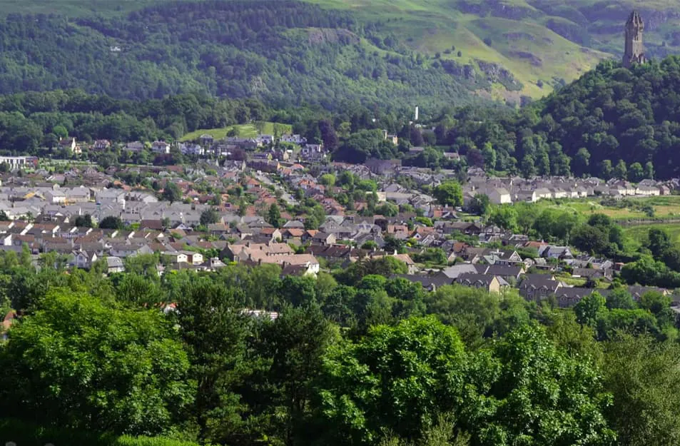 Houses and trees in a valley landscape