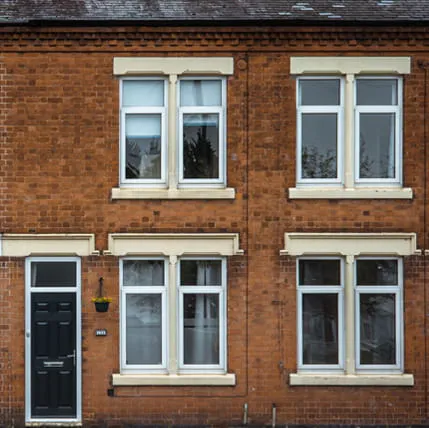 Terraced house with red brick and white windows