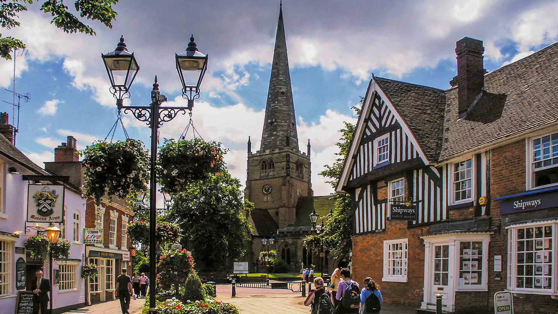Town square with church steeple and hanging flower baskets