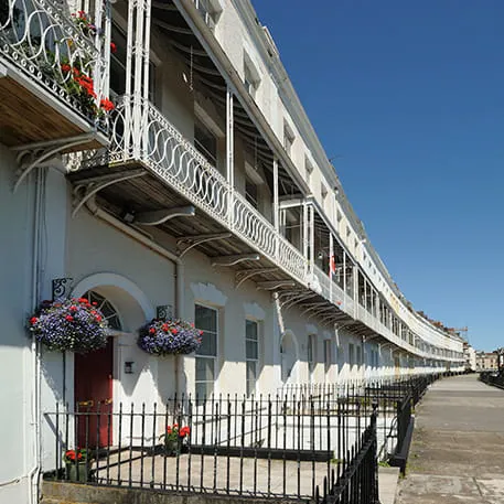 Cream coloured buildings with ornate balconies and flowers