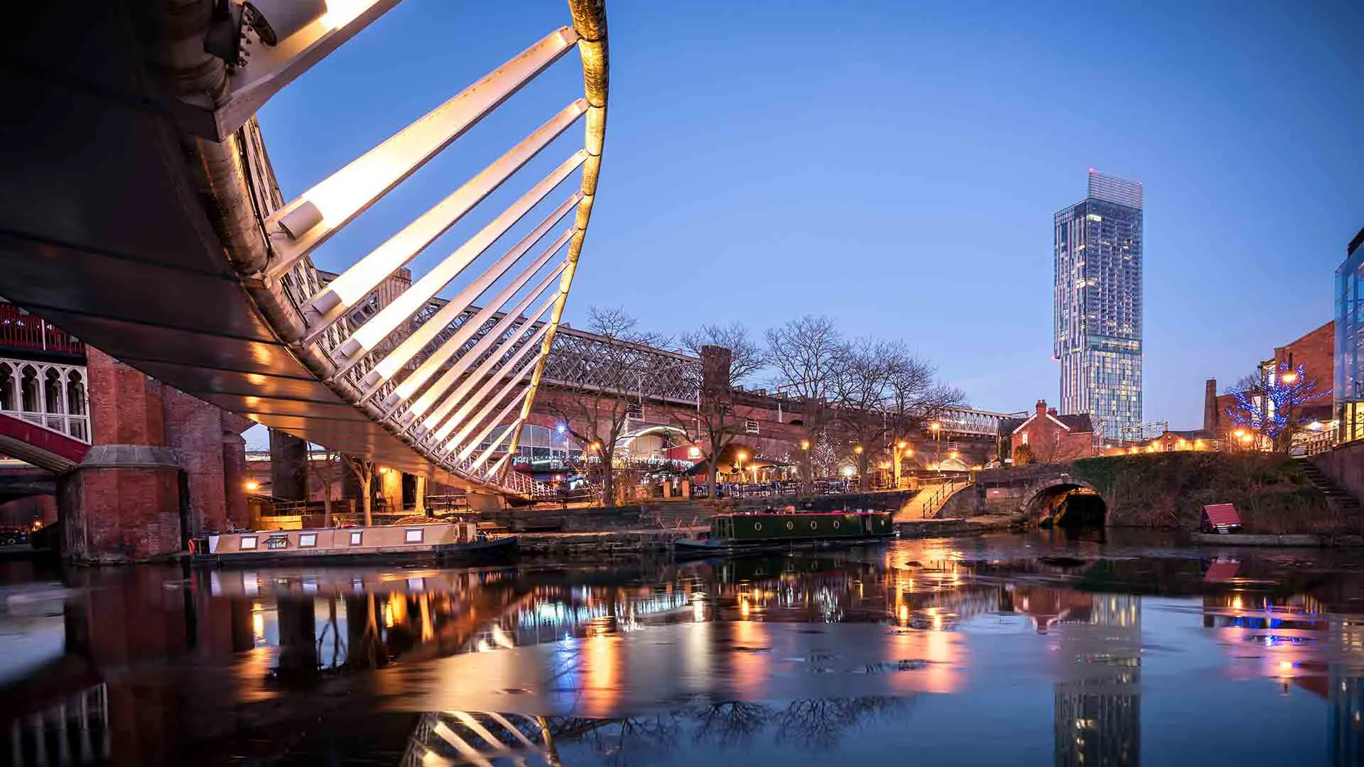 Canal city at twilight with modern architecture and bridge