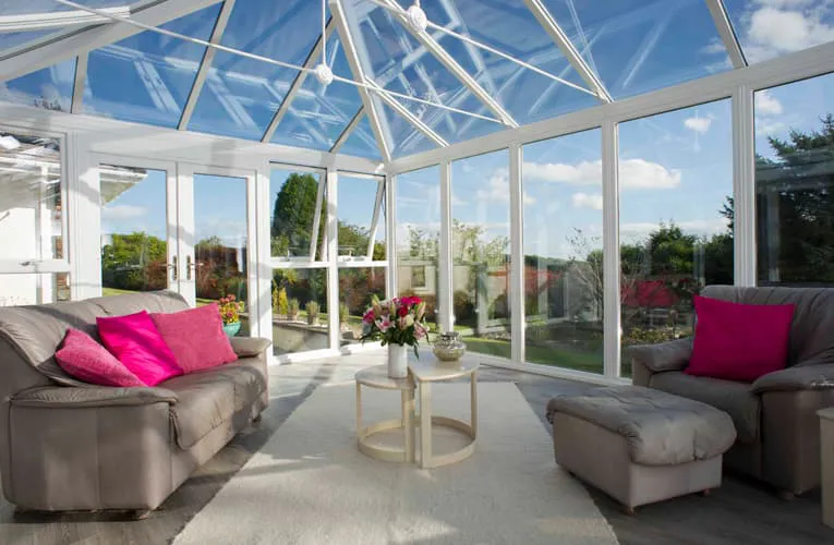 Everest conservatory with light gray sofas and pink cushions