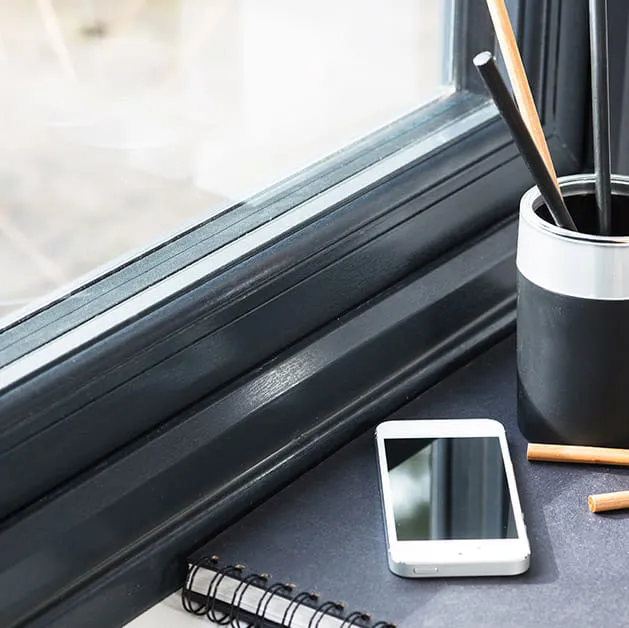 Dark grey Everest window frame with white phone and stationary