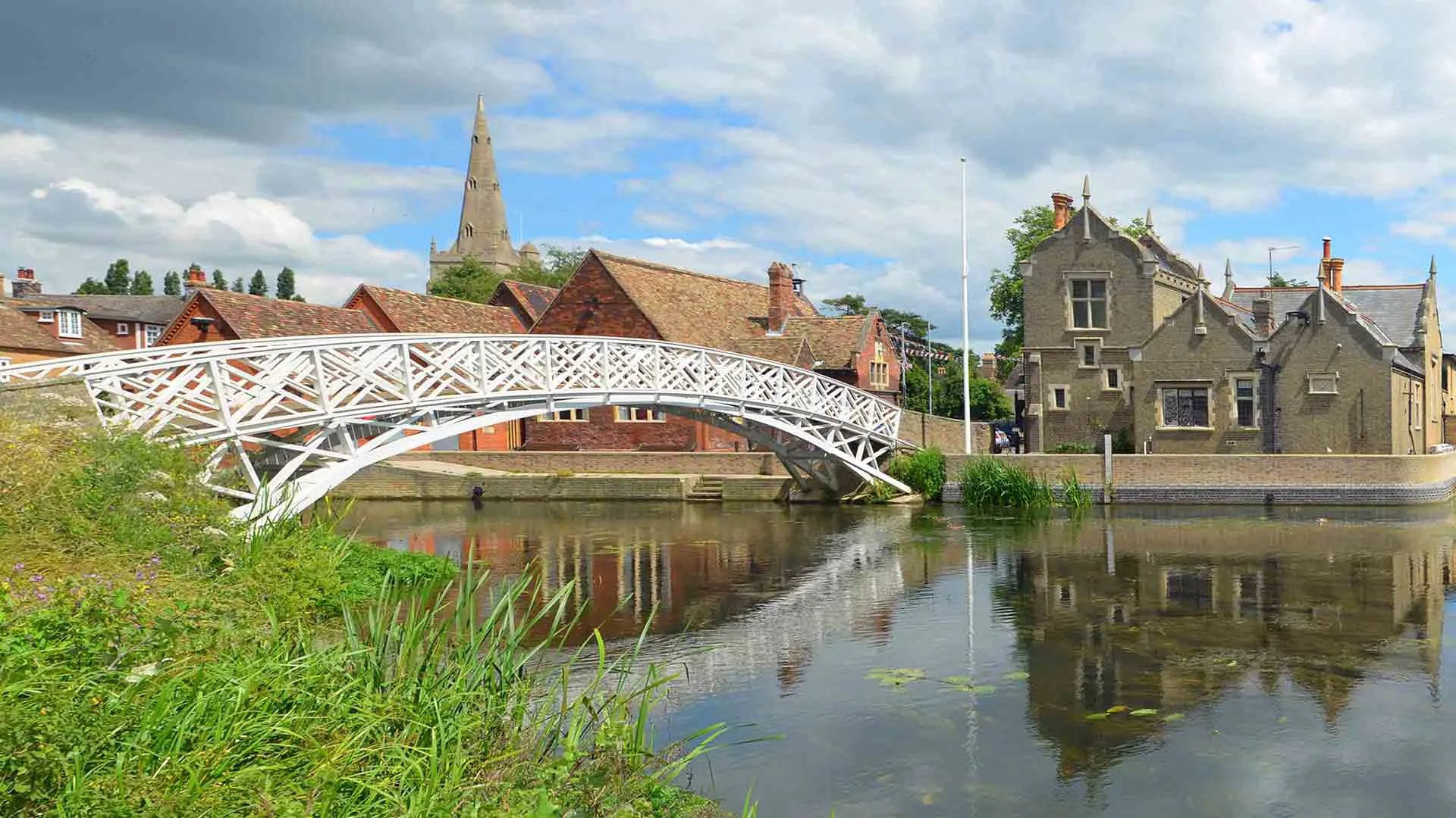 White arched bridge over a calm river